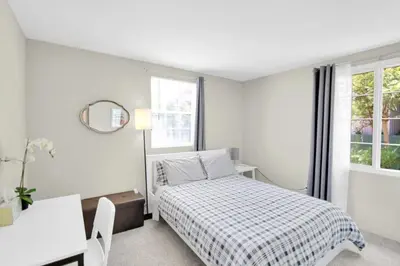 a bedroom with a bed and a desk and a window at Relax and Recharge here Close to All Attractions in San Diego