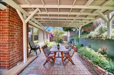 a patio with a table and chairs under a pergola at Relax and Recharge here Close to All Attractions in San Diego