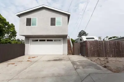 a house with a white garage door and a fence at Modern Loft Retreat - North Park San Diego in San Diego