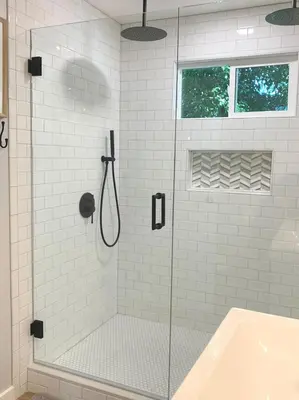a shower with a glass door in a bathroom at New cozy studio 2 queen beds kitchen walk to water! in San Diego