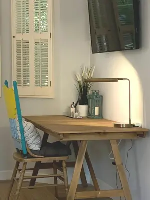 a wooden desk with a chair and a lamp at New cozy studio 2 queen beds kitchen walk to water! in San Diego