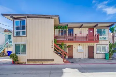 an apartment building with a balcony on a street at Mission Bay Getaway - Walk to the Water in San Diego