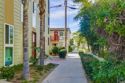 a sidewalk in front of houses with palm trees at Mission Bay Getaway - Walk to the Water in San Diego