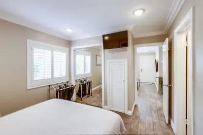 a bedroom with a white bed and a window at Mission Bay Getaway - Walk to the Water in San Diego