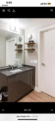 a bathroom with a sink and a mirror at Janna hospitality in San Diego