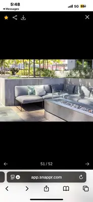 a tv screen with a couch and a bench at Janna hospitality in San Diego