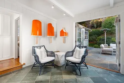 two chairs and a table in a room with a porch at Coastal Elegance by the Shore in San Diego