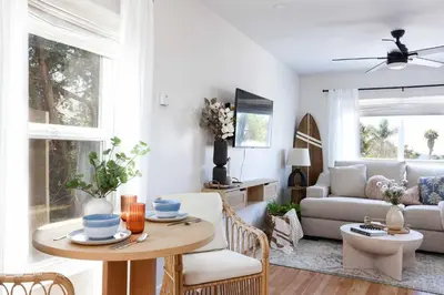 a living room with a table and a couch at Work-From-Beach Dream Ocean Views Hot tub, BBQ in Oceanside