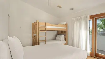 a bedroom with two bunk beds and a window at Resort-Style Estate w Pool Game Room Tennis Court Near Wineries The Tennis Ranch by AvantStay in Escondido