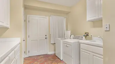 a kitchen with white cabinets and a white sink at Two Estates w Pools Hot Tubs Game Rooms Valley Views Tennis Court Near Beaches Wineries in Escondido