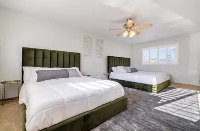 a bedroom with two beds and a ceiling fan at HUGE 5BR Family Retreat Backyard & Patio Lounge in Santee