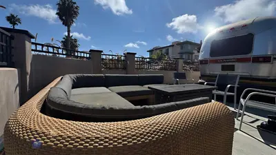 a patio with a couch and a table and a rv at Retro Star-Wagon, Ocean Breez at Studios in Oceanside