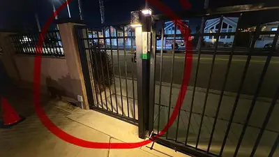 a gate with a red hose next to a street at Retro Star-Wagon, Ocean Breez at Studios in Oceanside