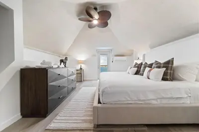a bedroom with a bed and a ceiling fan at Terrace Views at La Jolla Cove in San Diego