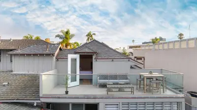 a house with a balcony with a table and chairs at Terrace Views at La Jolla Cove in San Diego