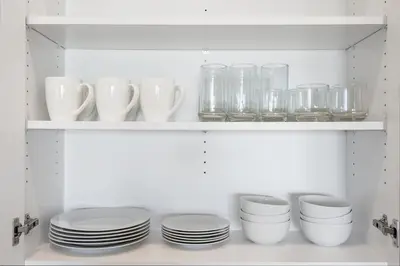 a white shelf with plates and glasses on it at Luxury Living in N Park, 2BR, King Beds, Parking in San Diego