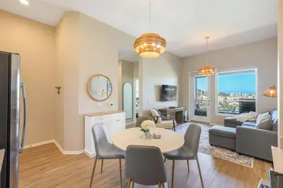 a living room with a table and a couch at Luxury Living in N Park, 2BR, King Beds, Parking in San Diego