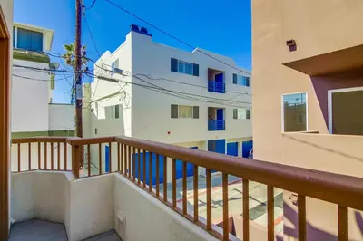 a balcony view of a building with blue windows at Stunning beach home located between bay and beach with Ocean View Patio in San Diego