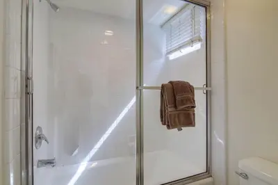 a shower with a glass door in a bathroom at Stunning beach home located between bay and beach with Ocean View Patio in San Diego