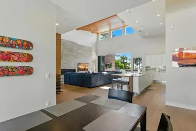a kitchen and living room with a table and a couch at Luxury Stay with Pool, Spa, Fire Pit, Outdoor Lounge & Stunning Ocean Views, Encinitas Retreat in Encinitas