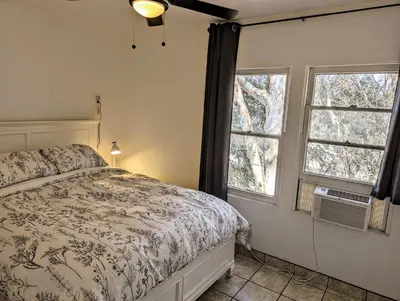 a bedroom with a bed and two windows at Large 3 Bedroom near everything in San Diego in San Diego