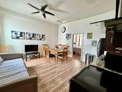 a living room with a dining table and a ceiling fan at Walk everywhere heart Gaslamp in San Diego