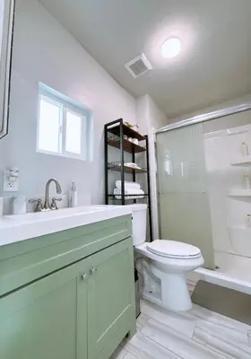a bathroom with a toilet and a sink and a shower at Modern Cozy Stylish Home AC WasherDryer Parking 3 minutes to Balboa Park in San Diego