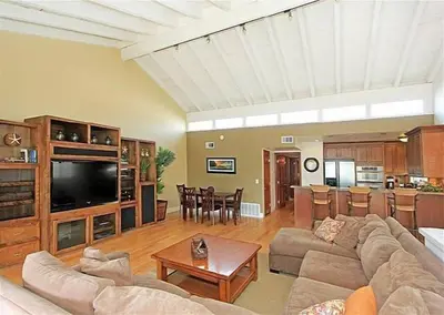 a large living room with a couch and a table at Get Your Vitamin Sea! Steps to Sand, Bikes, & Balcony in Newport Beach