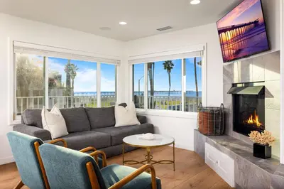 a living room with a couch and a fireplace at Stunning OB Ocean View Stay in San Diego