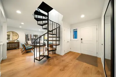 a hallway with a spiral staircase in a house at Stunning OB Ocean View Stay in San Diego
