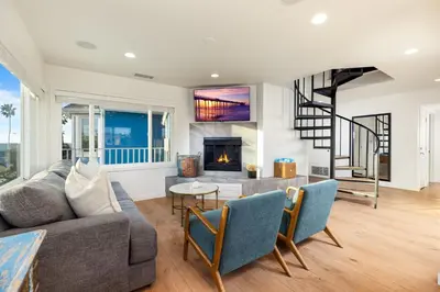 a living room with a couch and a fireplace at Stunning OB Ocean View Stay in San Diego
