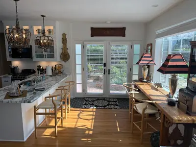 a kitchen with a bar with chairs and a table at La Jolla Carriage House in San Diego