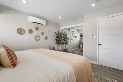 a bedroom with a large white bed and a white wall at Wellness Bnb - Your San Diego Retreat in San Diego