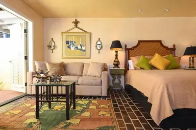 a bedroom with a bed and a couch at Hidden Casita with Private Deck & Patio in San Diego