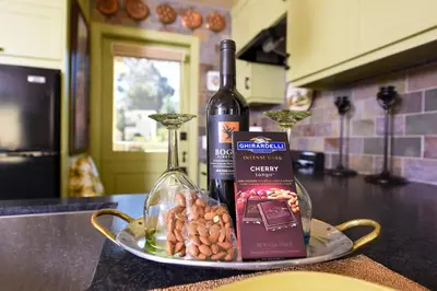 a bottle of wine and a plate of nuts at Hidden Casita with Private Deck & Patio in San Diego