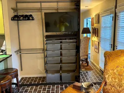 a living room with a tv and some drawers at Hidden Casita with Private Deck & Patio in San Diego