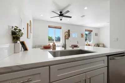 a kitchen with a sink and a ceiling fan at Luxury Oasis Compound with Hot Tub with 3 Homes in Escondido