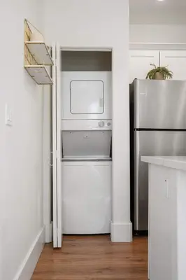 a kitchen with a refrigerator and a washer and dryer at Luxury Oasis Compound with Hot Tub with 3 Homes in Escondido
