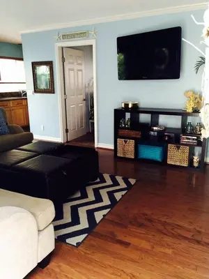 a living room with a couch and a flat screen tv at 6BR Beach House w/ Bikes/Fire pit/BBQ/Easy Parking in Newport Beach