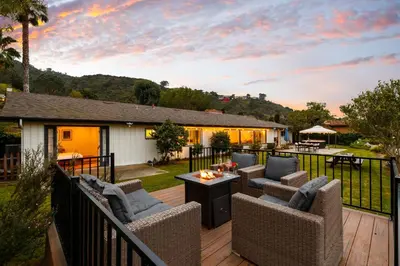 a deck with wicker chairs and a fire pit at Ocean View Retreat Firepit & Spacious Yard in San Diego