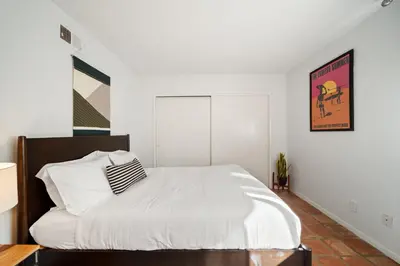 a bedroom with a large bed with white sheets at Ocean View Retreat Firepit & Spacious Yard in San Diego