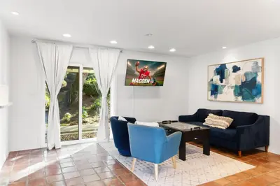 a living room with a blue couch and a table at Ocean View Retreat Firepit & Spacious Yard in San Diego