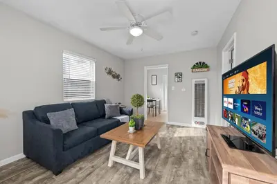 a living room with a couch and a tv at Prime North Park Stay, Walk to Restaurants, Bars, and Breweries with Free Parking in San Diego