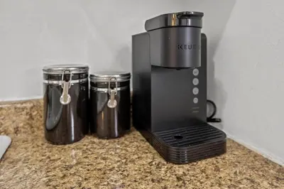 a coffee maker sitting on a counter next to two containers at Colorful & Cozy Oasis in North Park Walk to Restaurants, Bars, and Breweries in San Diego