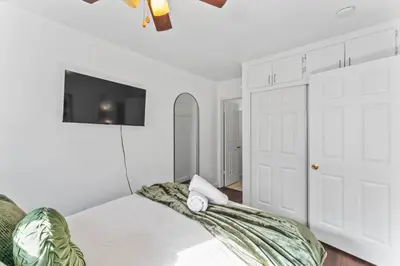 a bedroom with a bed and a flat screen tv at Colorful & Cozy Oasis in North Park Walk to Restaurants, Bars, and Breweries in San Diego