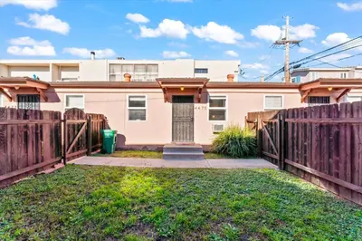 a house with a wooden fence and a door at Colorful & Cozy Oasis in North Park Walk to Restaurants, Bars, and Breweries in San Diego