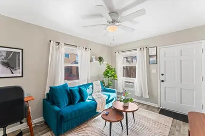 a living room with a blue couch and a table at Stylish & Comfy Gem in North Park, Walk to Restaurants, Bars, and Breweries in San Diego