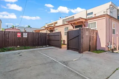 a fence with two gates in front of a house at Stylish & Comfy Gem in North Park, Walk to Restaurants, Bars, and Breweries in San Diego