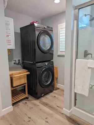 a washing machine in a room with a bathroom at Alpine's Gorgeous Guest Home in Alpine