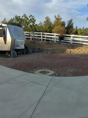a trailer parked next to a white fence at Alpine's Gorgeous Guest Home in Alpine
